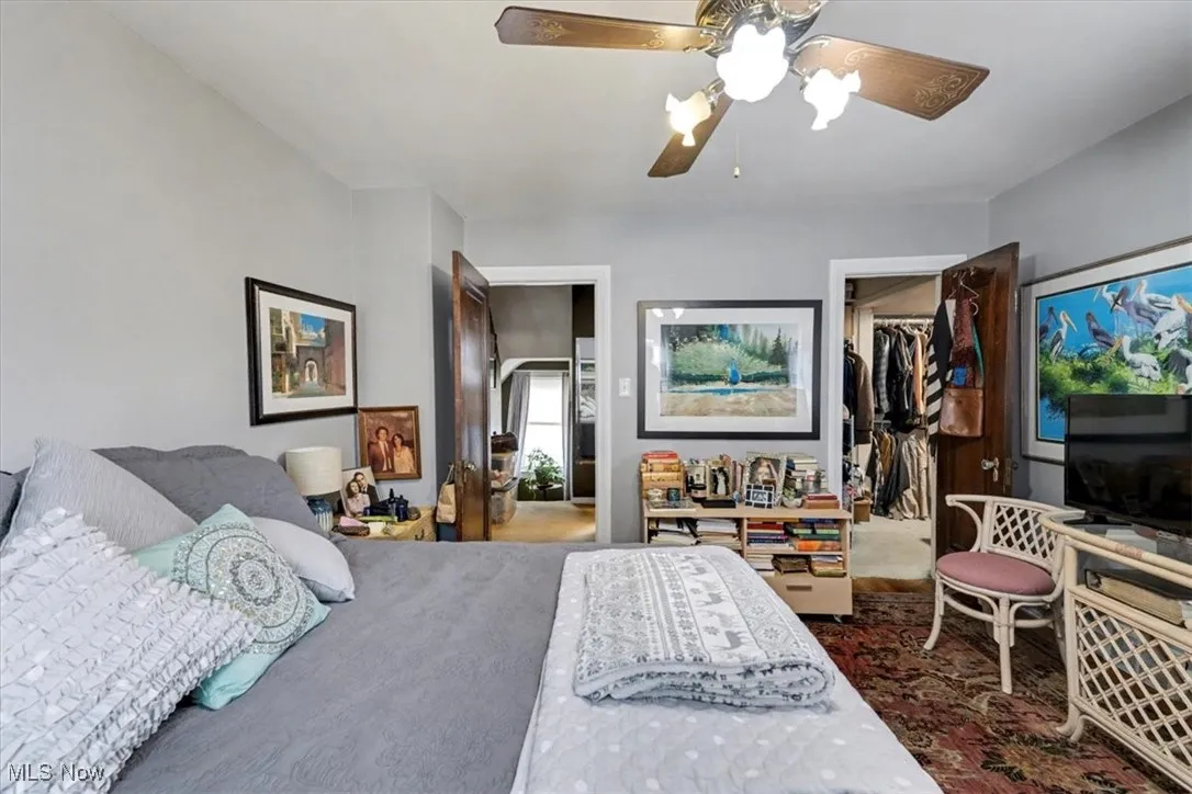 Bedroom featuring a walk in closet and ceiling fan