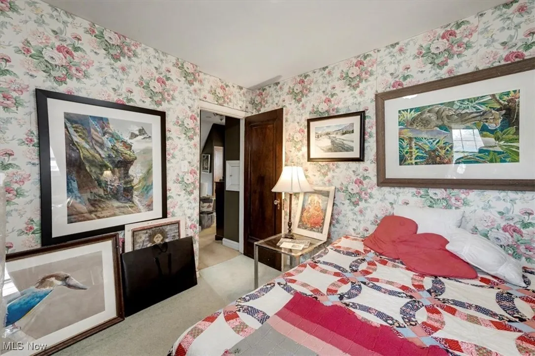 Bedroom with ensuite bath and wallpapered walls