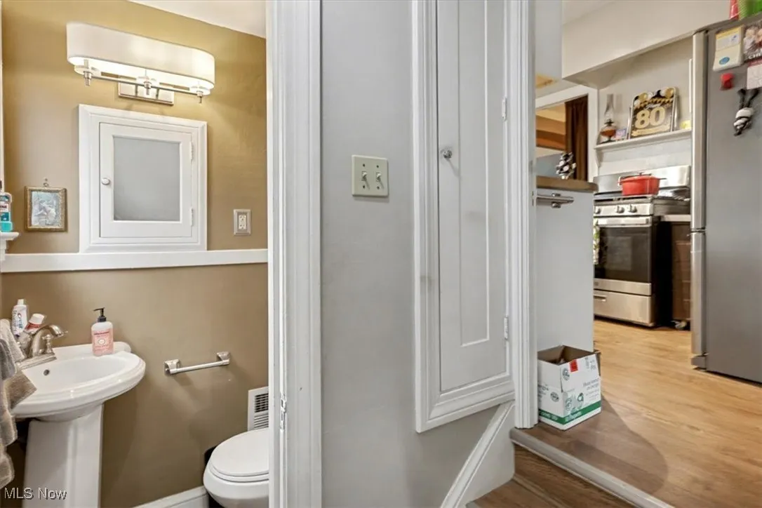 Bathroom with wood finished floors and toilet