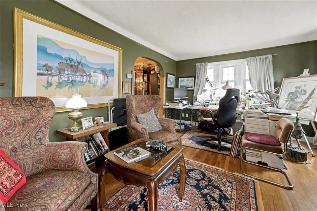 Office area with wood-type flooring and a textured ceiling