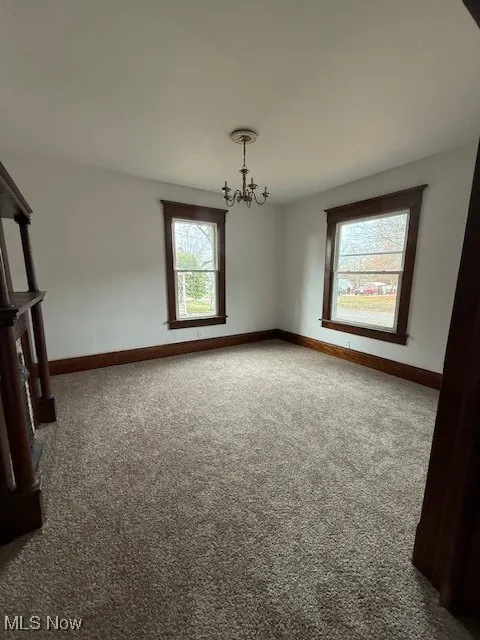 Living room with a chandelier and new carpet