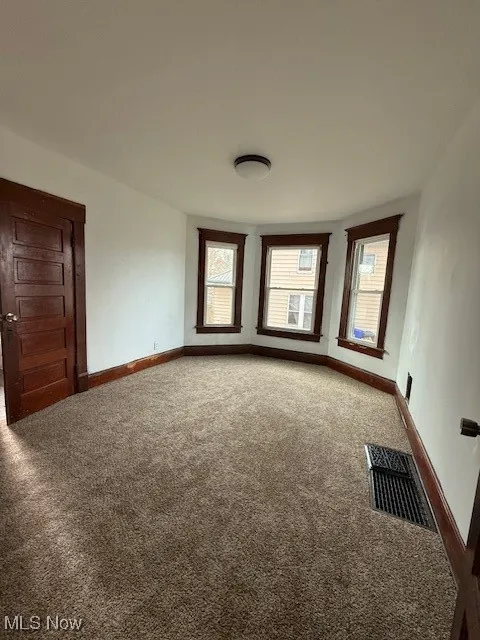First floor bedroom featuring lots of natural light, new carpet, freshly painted