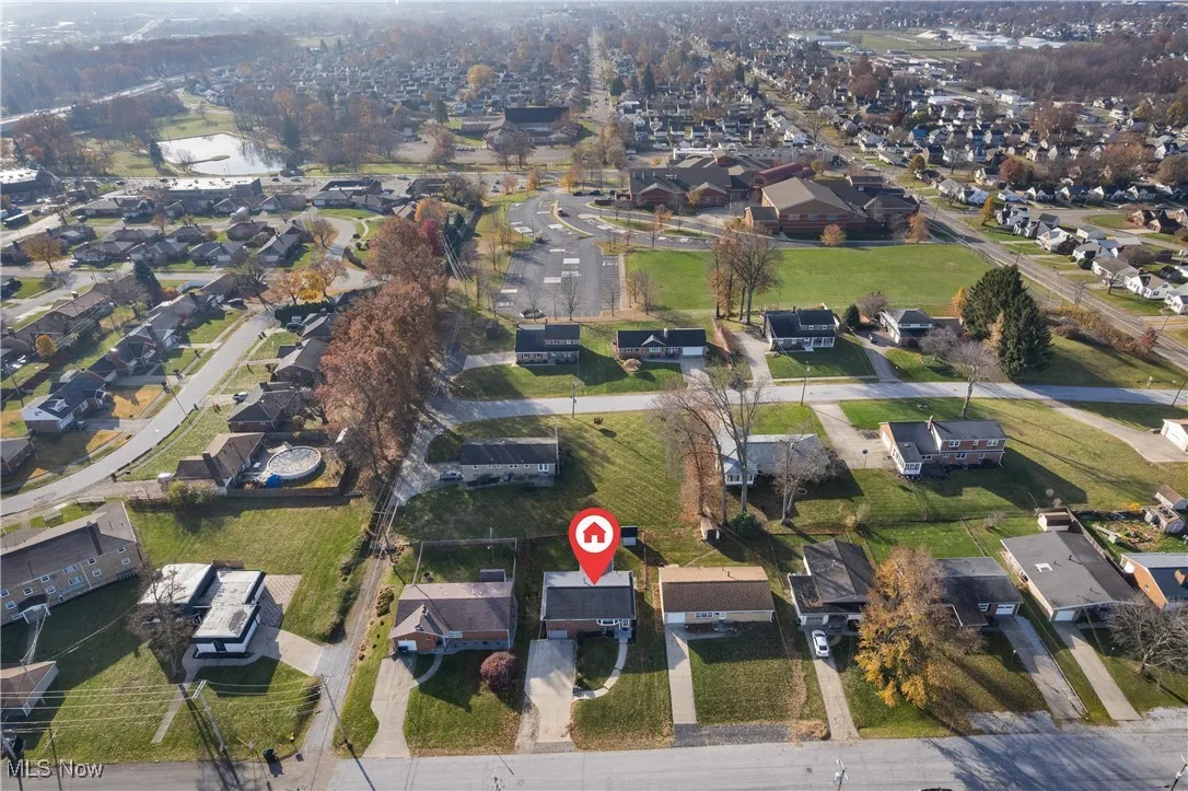 Aerial view of property's location with nearby suburban area