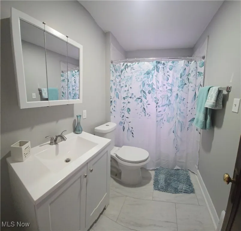 2nd level Full bath with vanity and a shower with shower curtain