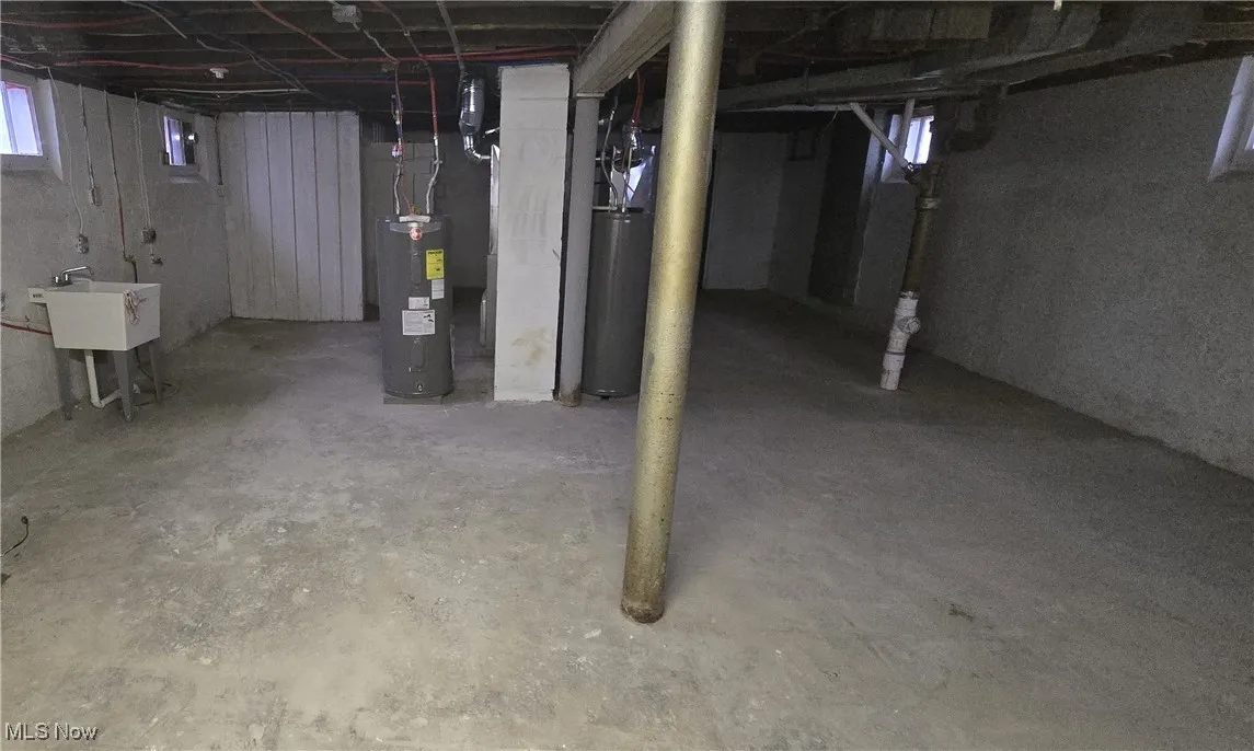 Below grade area featuring water heater