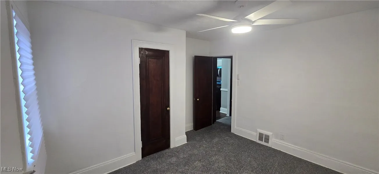 2nd level bedroom 1 featuring dark carpet, a closet, and a ceiling fan