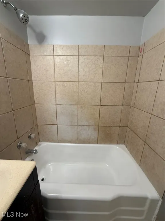 Bathroom featuring vanity and bathtub / shower combination