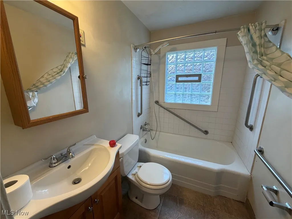 Bathroom with vanity and shower / bath combination