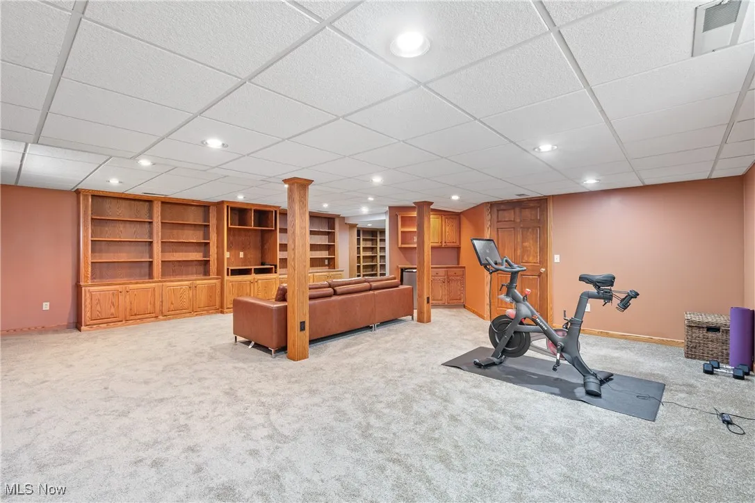 Exercise area with recessed lighting, light carpet, and a drop ceiling