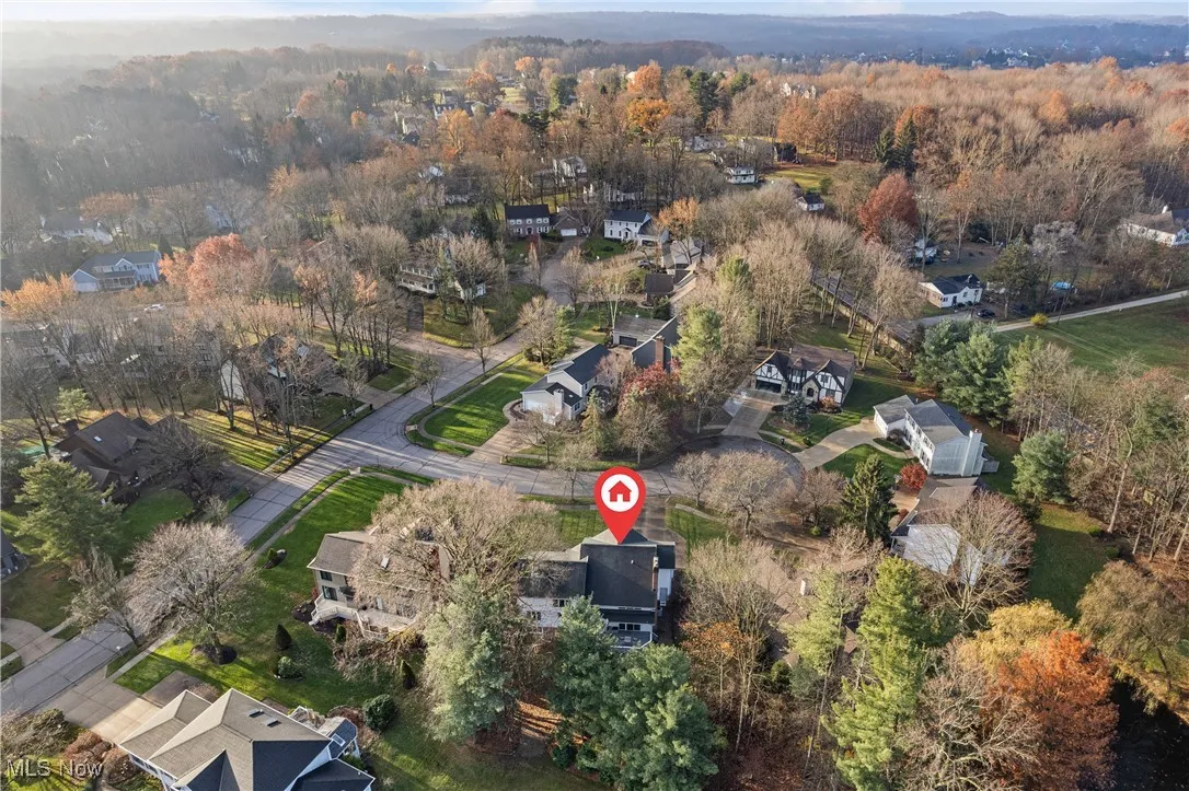 Aerial view of property and surrounding area with nearby suburban area