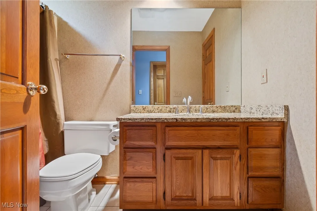Bathroom featuring vanity and a textured wall