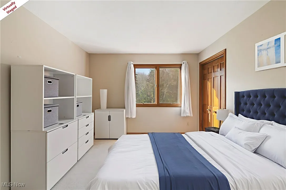 Bedroom featuring a closet and light colored carpet