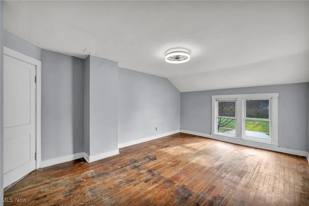 Additional living space featuring lofted ceiling and hardwood / wood-style flooring
