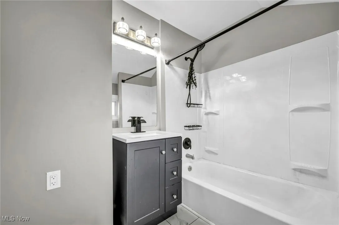 Bathroom with shower / tub combination and vanity