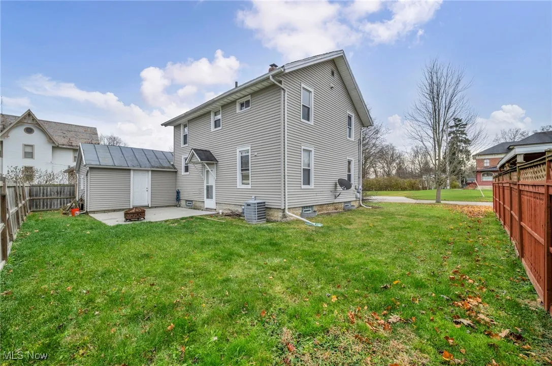 Rear view of property featuring a fenced backyard and a patio area