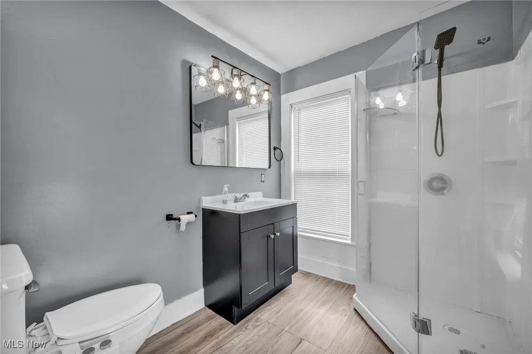 Bathroom with a shower stall, vanity, and light wood finished floors