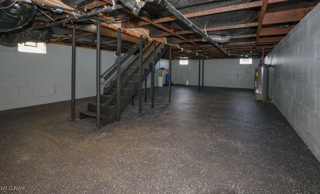 Basement with stairs and water heater