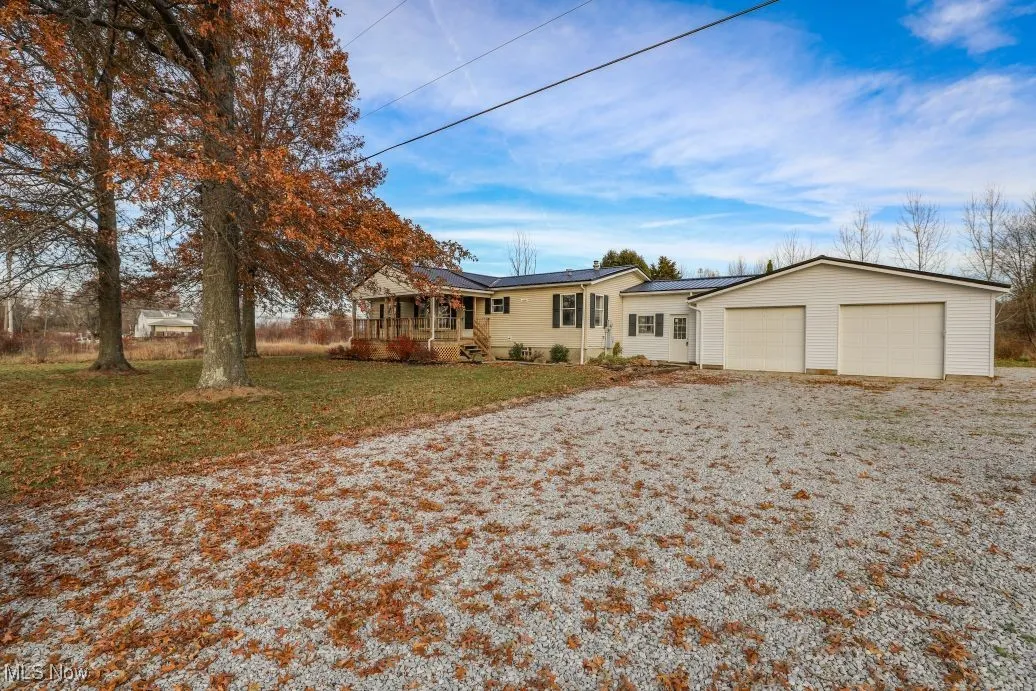 Ranch-style home featuring a garage and a front lawn