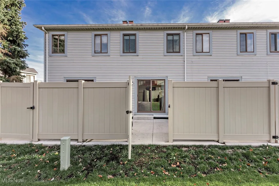 Rear view of property featuring a gate