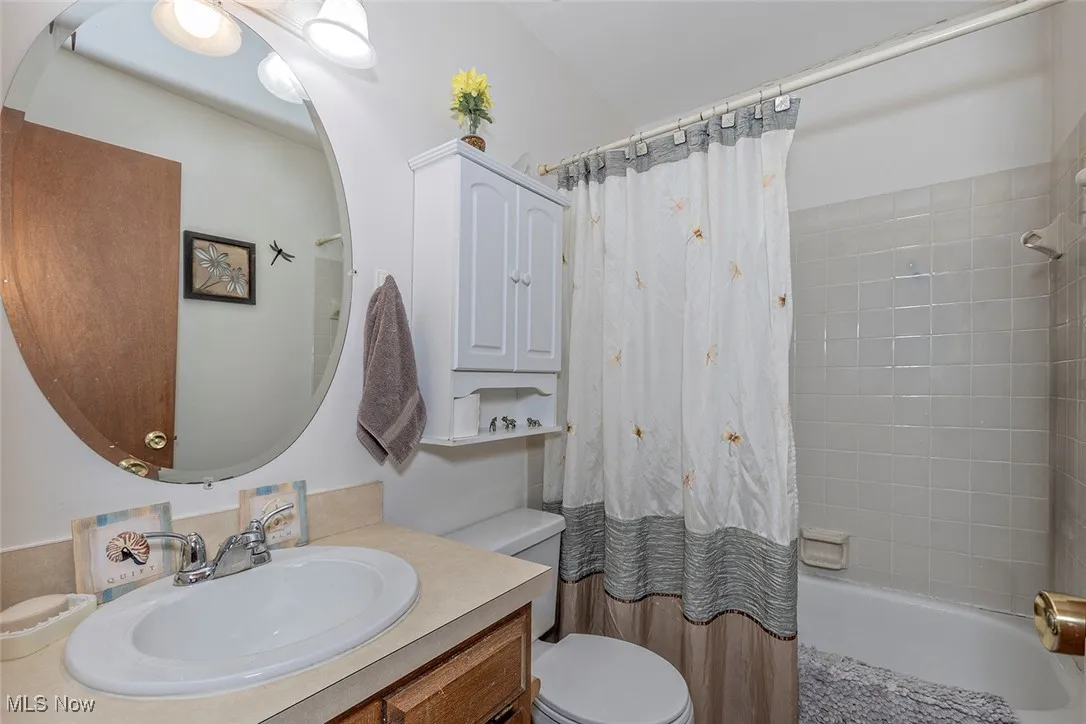 Full bath with vanity and shower / bathtub combination with curtain
