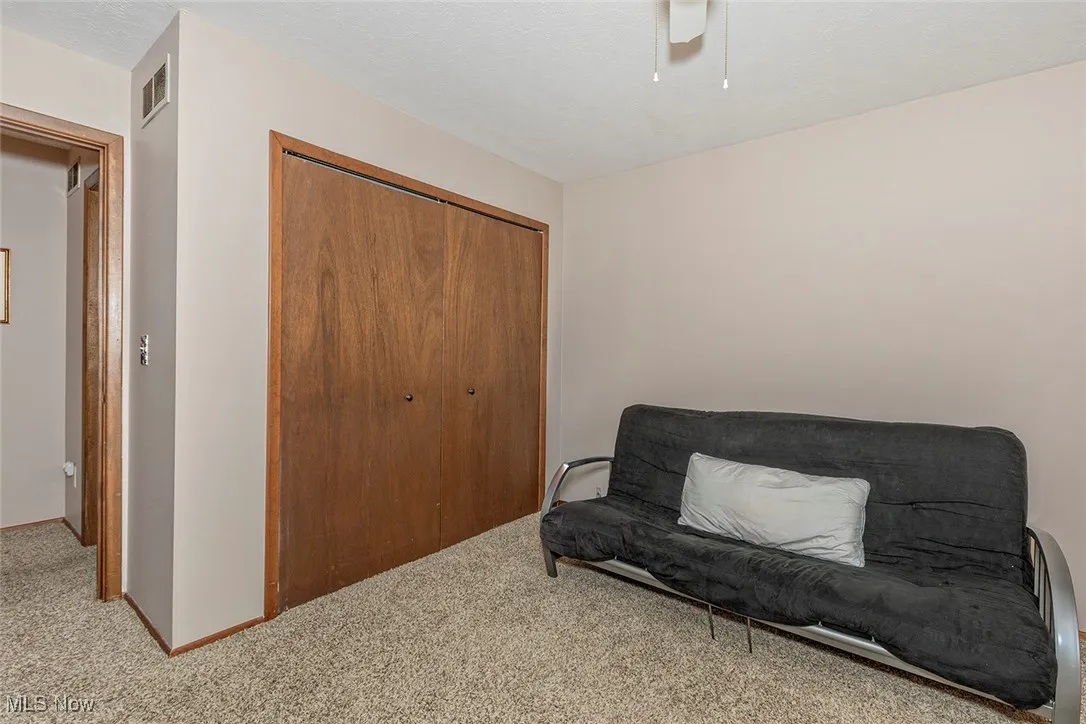 Sitting room with carpet and baseboards