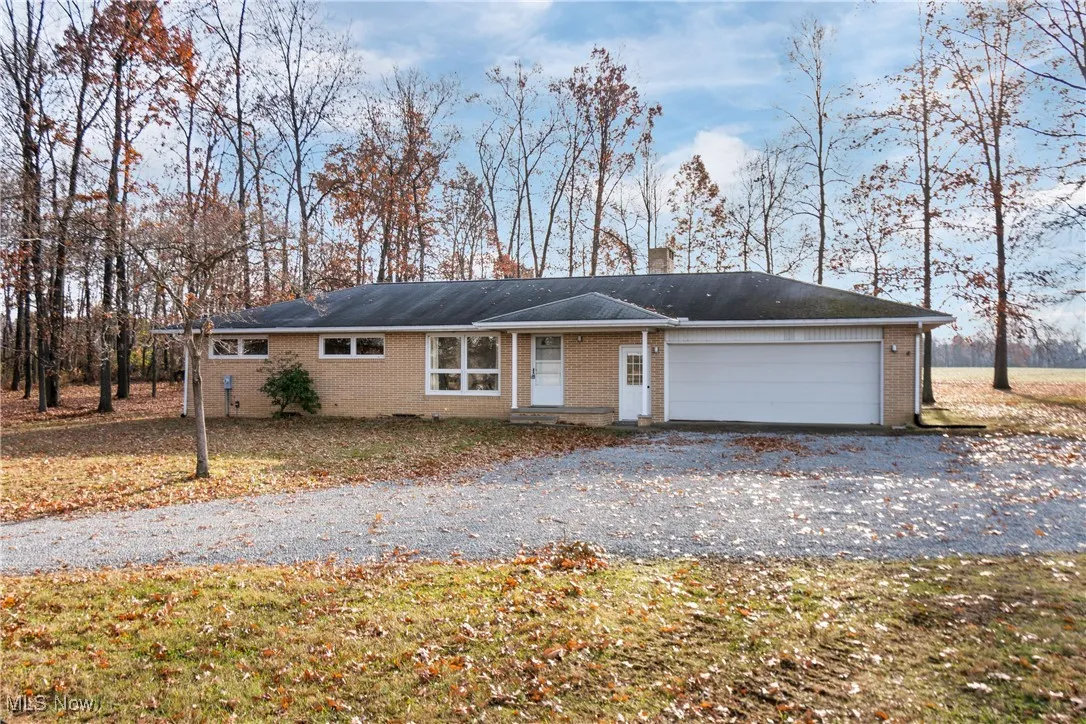 Ranch-style home with brick siding, driveway, and an attached garage