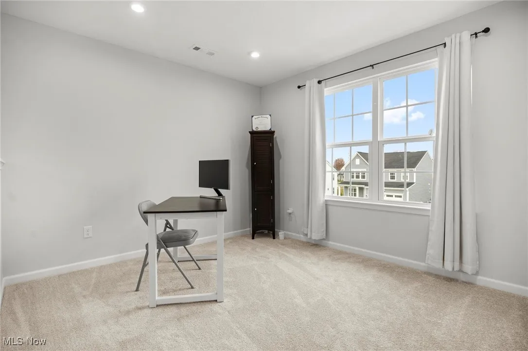 Unfurnished office featuring light carpet and recessed lighting