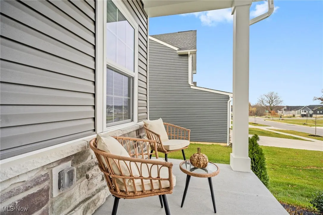 Covered porch with a lawn