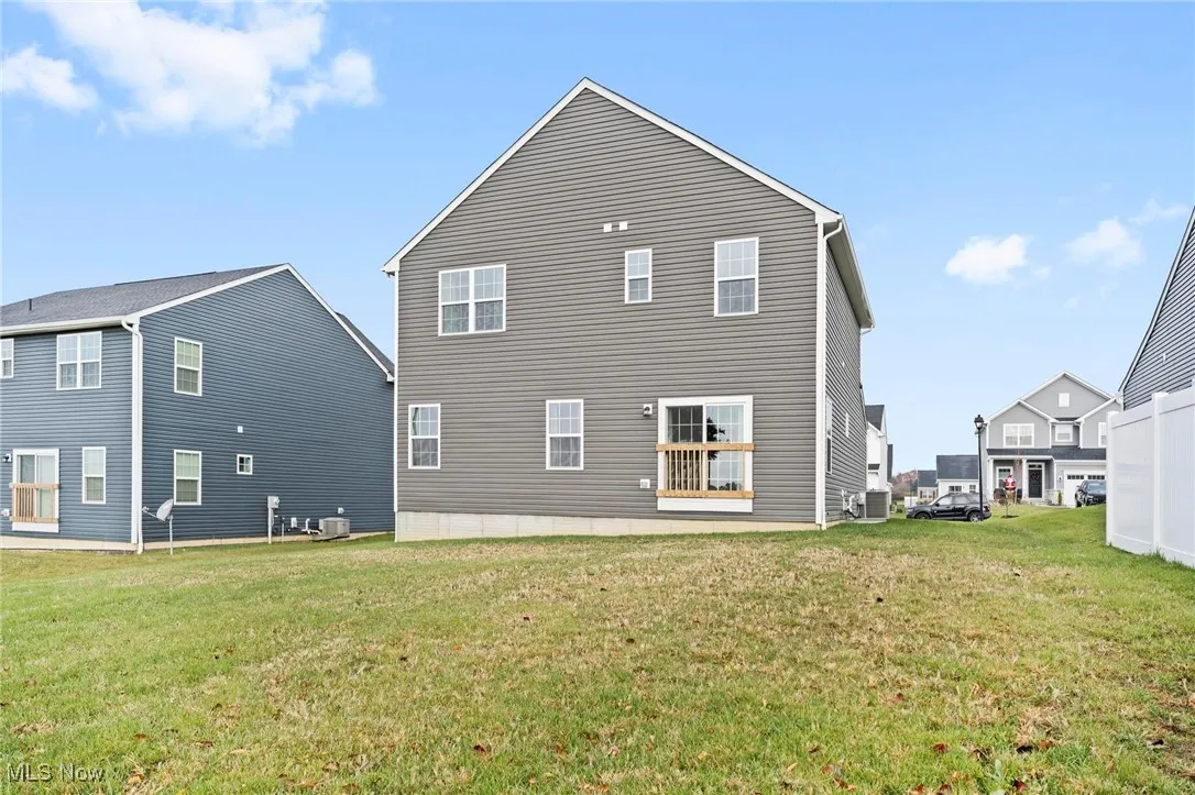 Rear view of house featuring a lawn