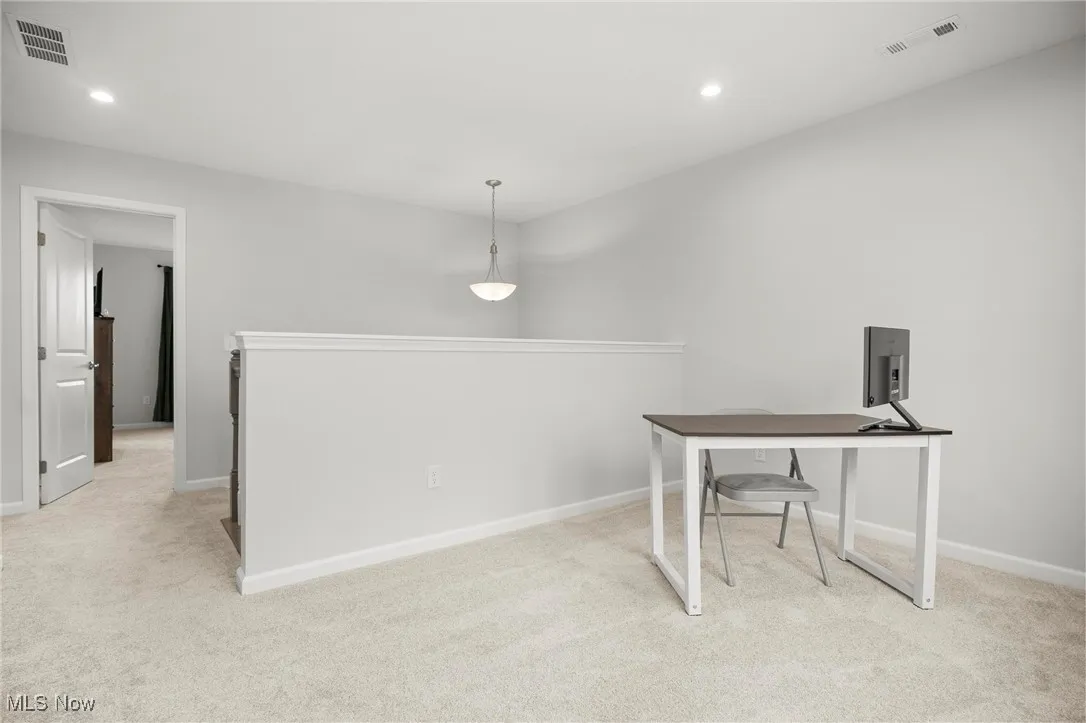 Unfurnished office featuring light carpet and recessed lighting