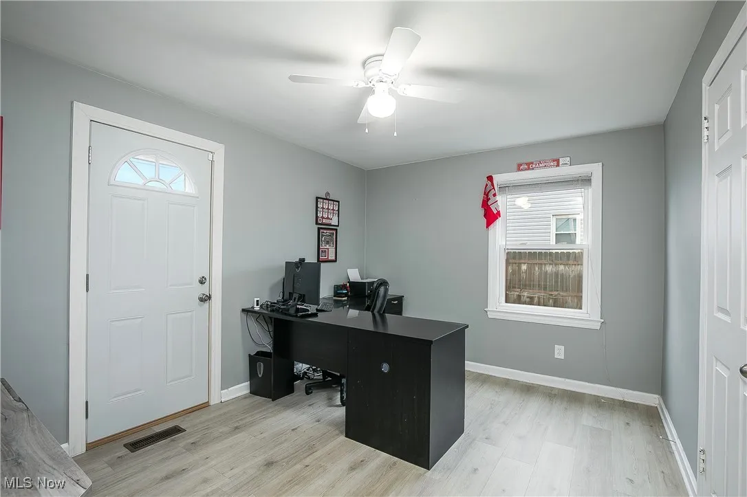Office area featuring plenty of natural light, light wood finished floors, and a ceiling fan