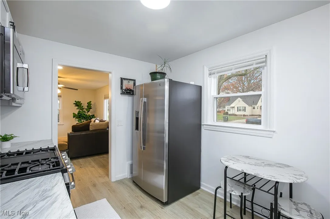 Kitchen with stainless steel appliances, light wood finished floors, and light countertops