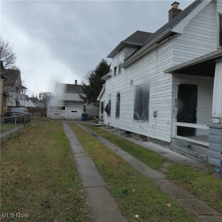 View of side of property featuring a chimney