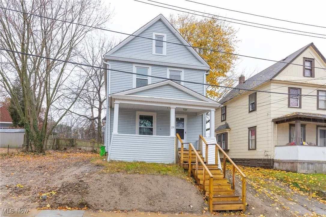 American foursquare style home with covered porch