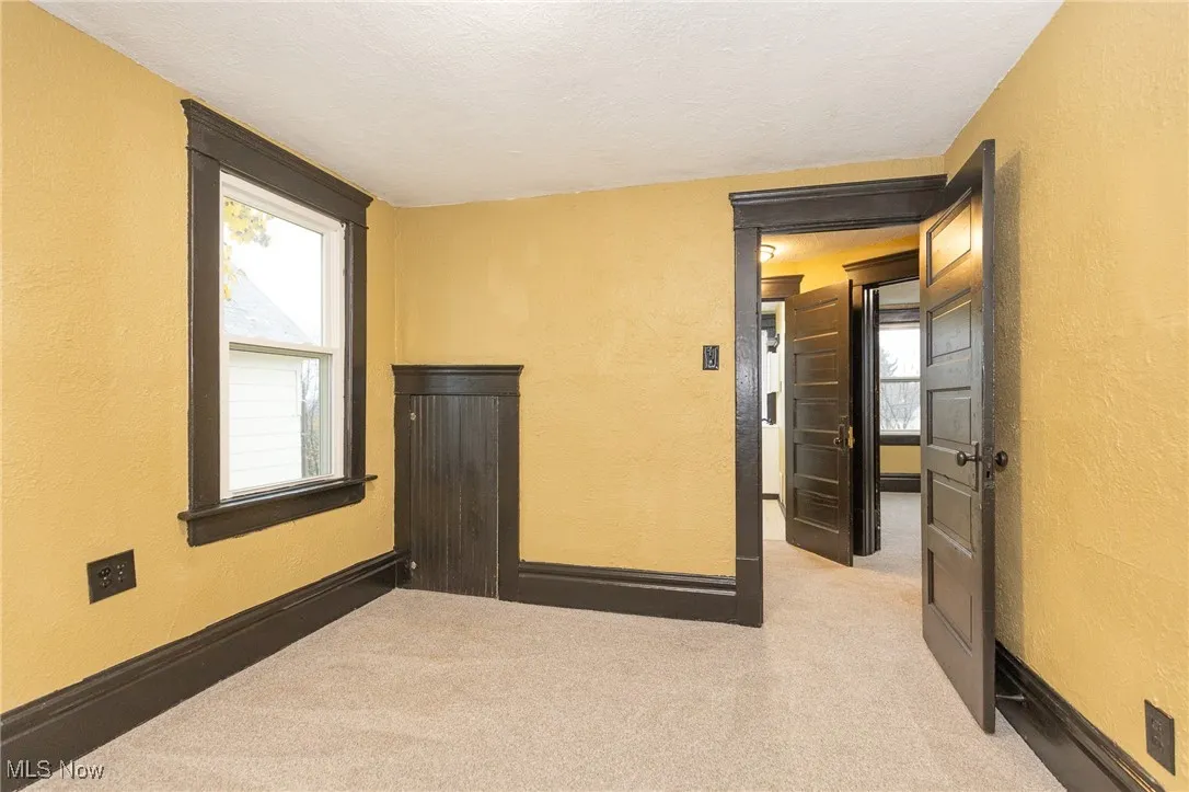 Spare room featuring a textured wall, a textured ceiling, and light​​‌​​​​‌​​‌‌​‌‌​​​‌‌​‌​‌​‌​​​‌​​ carpet