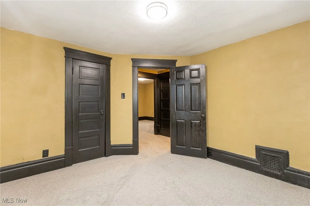 Unfurnished bedroom with carpet flooring and a textured ceiling