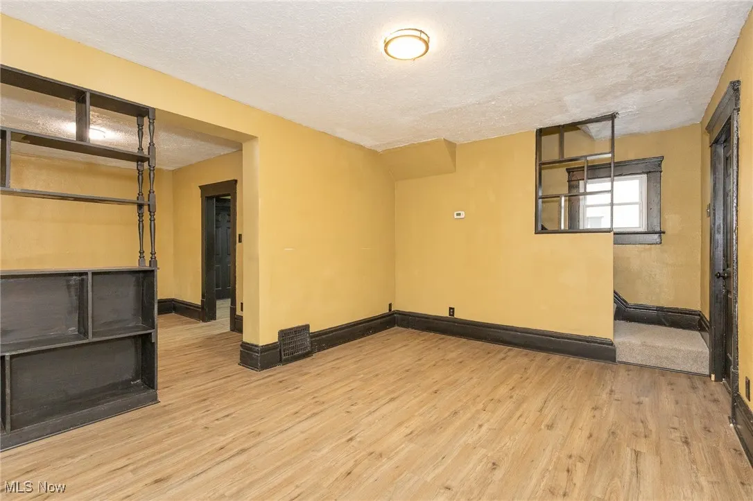 Unfurnished room featuring a textured ceiling and light wood-type flooring