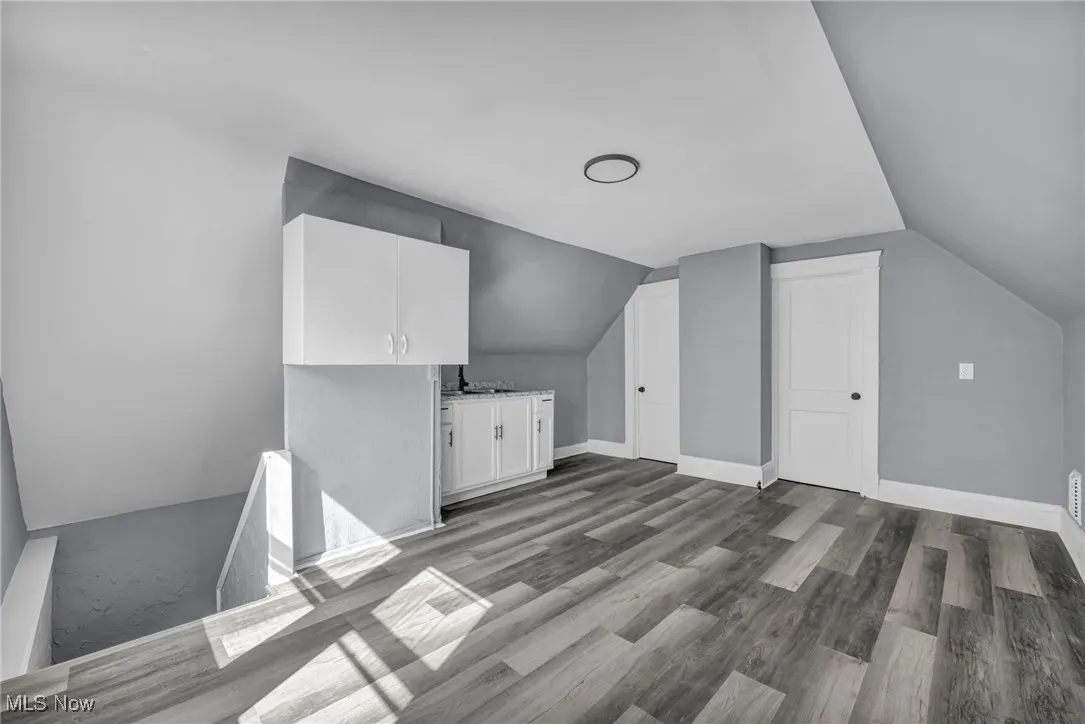 Bonus room featuring lofted ceiling and light wood-style floors