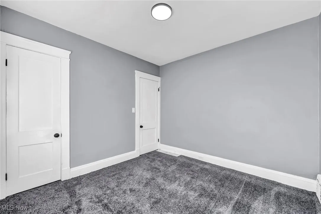 Unfurnished bedroom featuring baseboards and carpet floors