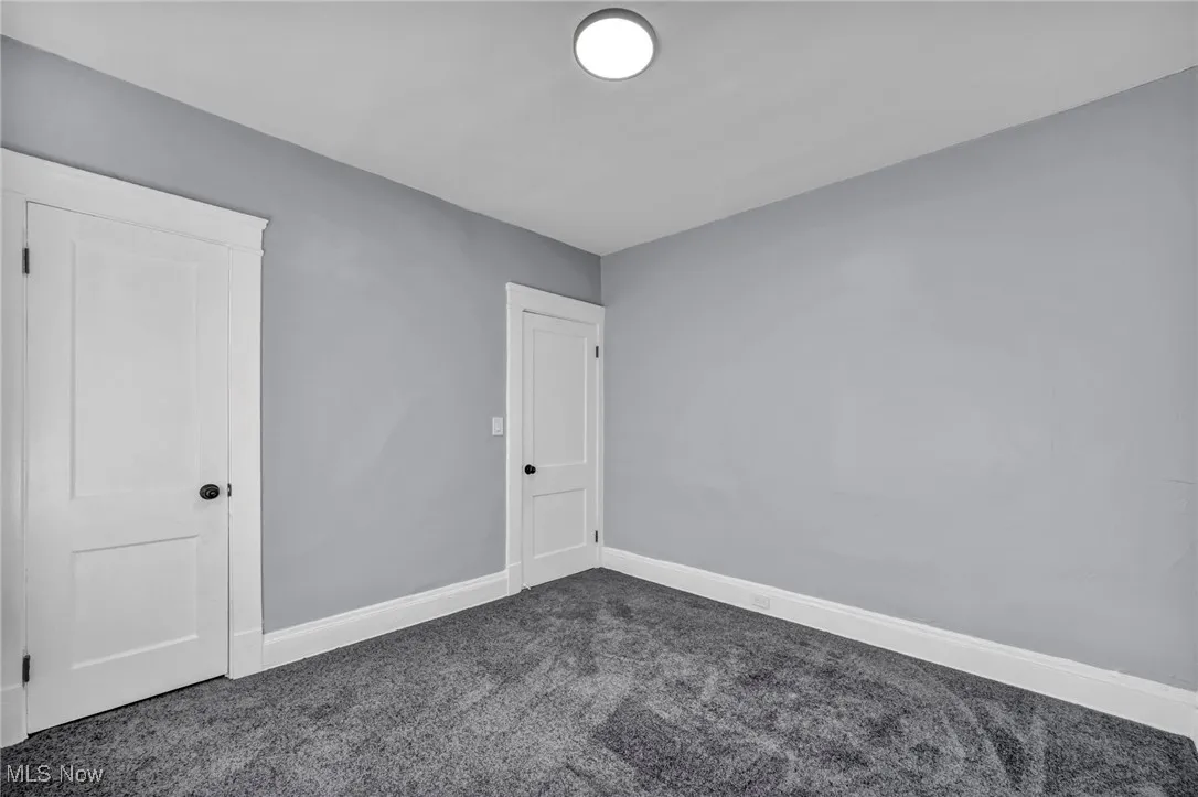 Unfurnished room featuring baseboards and carpet flooring