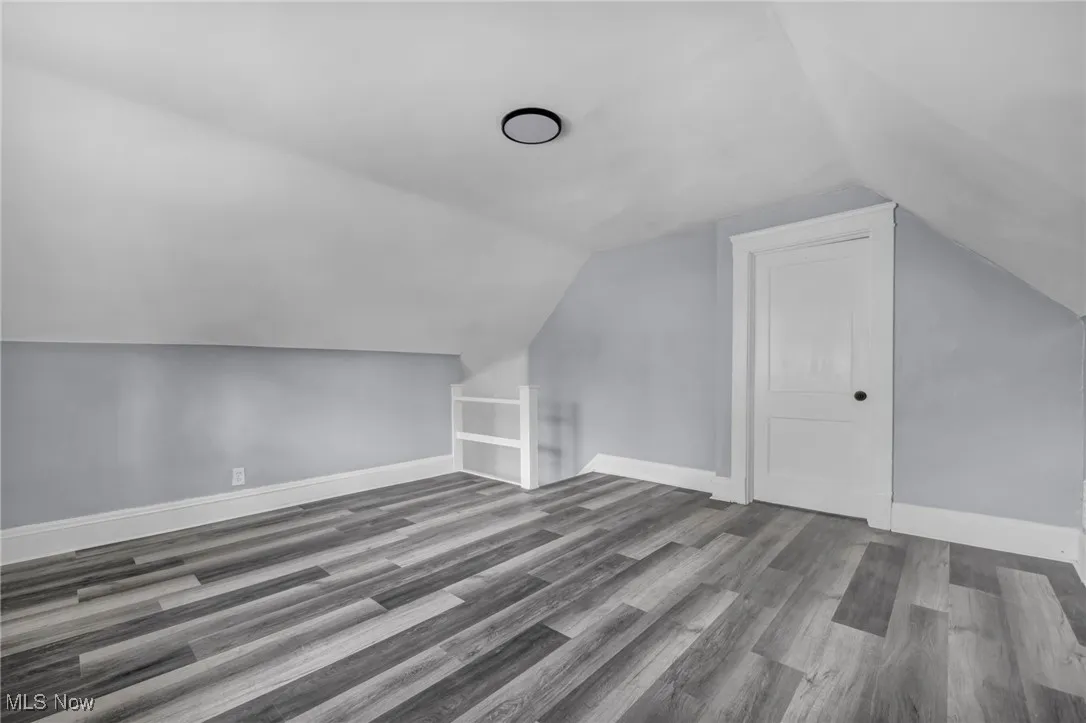 Bonus room with wood finished floors and lofted ceiling
