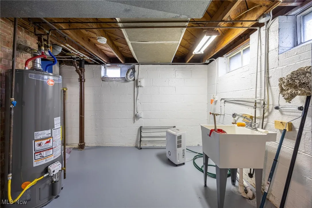 Basement with water heater and plenty of natural light