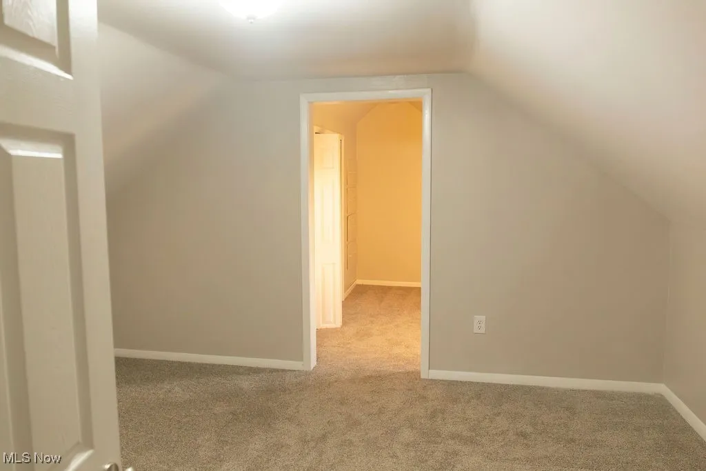 Bonus room featuring carpet flooring and lofted ceiling