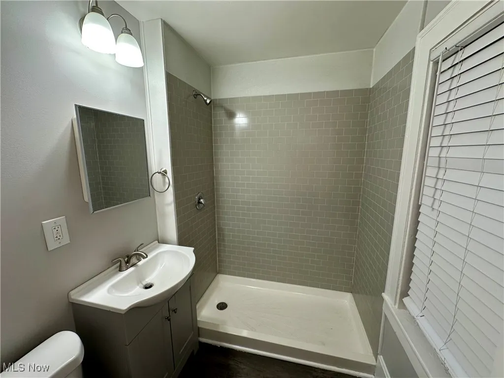 Bathroom with a stall shower and vanity