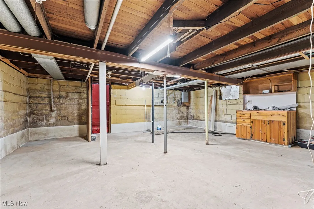 Unfinished basement with electric panel