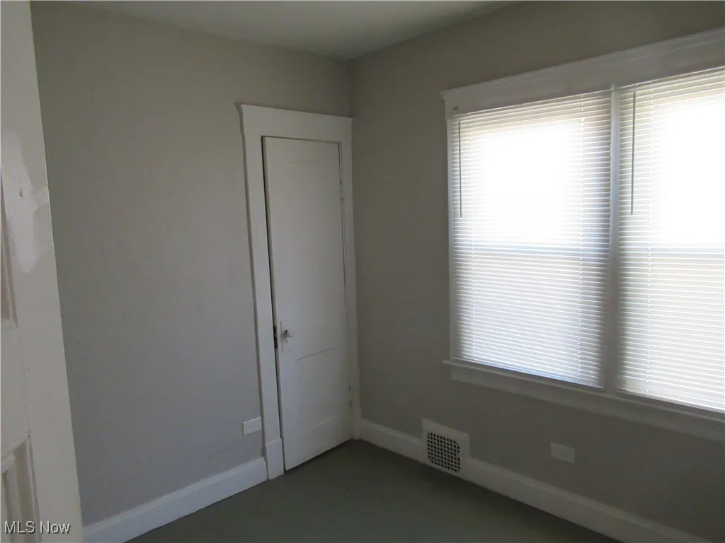 Spare room featuring baseboards