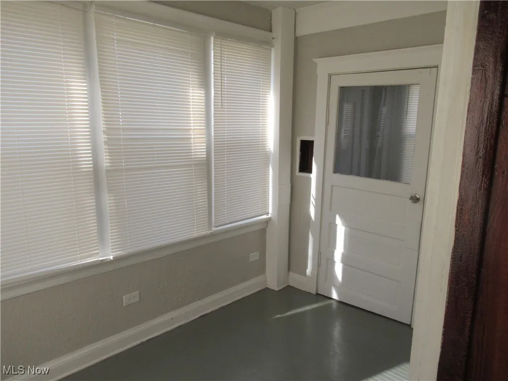 Foyer with concrete floors and baseboards