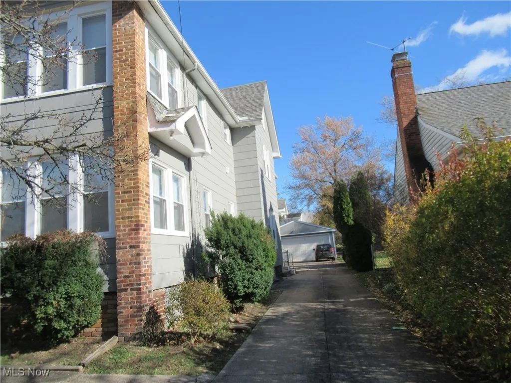 View of property exterior featuring an outdoor structure and a garage