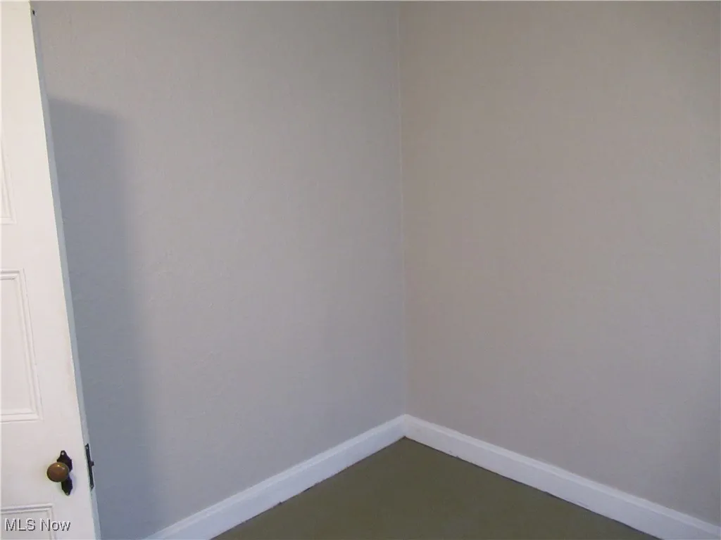 Empty room featuring baseboards