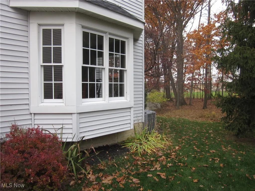 View of side of property with a central air condition
